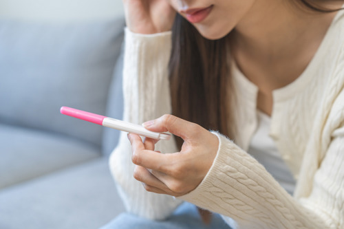 Woman doing an ovulation test to detect her fertile days.